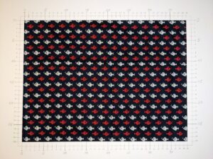 A light fabric with animals pattern, red/white on navy (ID: FL087)